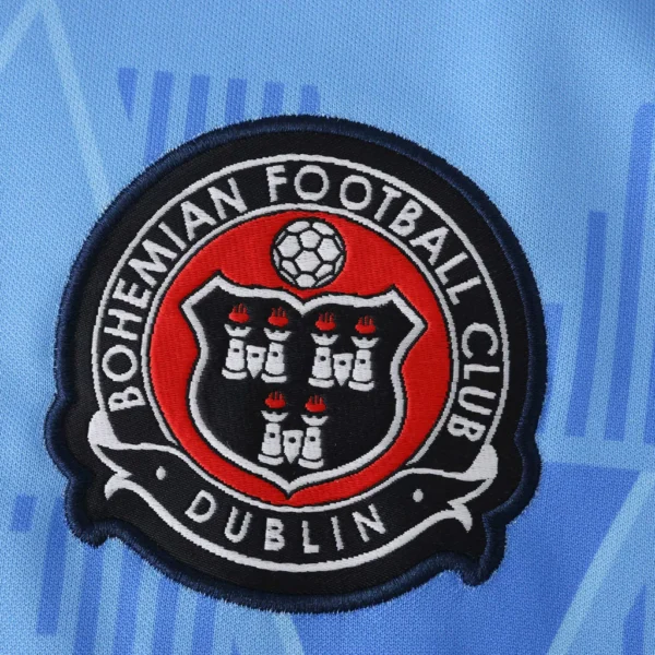 ec0ea945-5ea8d34b0cf30a8b5217550275630632-1024-1024 Camisa Bohemian FC x Oasis Away 2025/2026 Azul - Imagem 2
