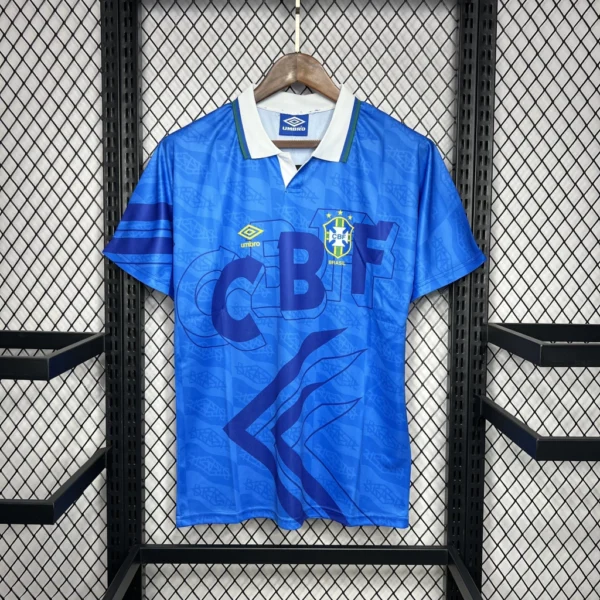 camisa-do-brasil-1991-away1-e23513aedb8b20af8217193610664211-1024-1024 Camisa Retrô Clássica Seleção Brasileira Away - Brasil Azul – 1991 Umbro - Imagem 1